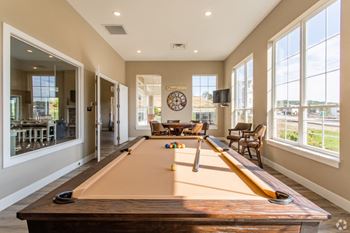 a pool table in a living room with large windows at The Flats at Summit Station, South Park, 15129